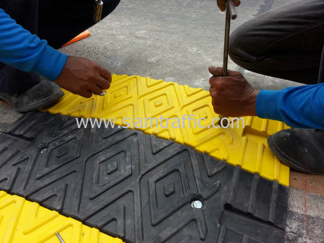 Installation of yellow and black plastic speed bump at Chachoengsao Province